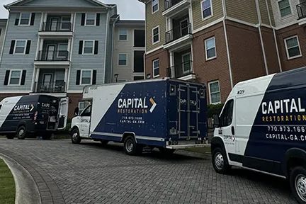 Capital Restoration trucks at an apartment complex