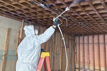Capital Restoration technician treating a ceiling for mold
