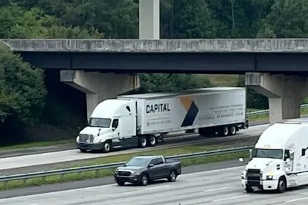 Capital Restoration trucks on the highway