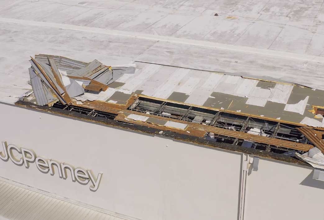 A shopping mall roof torn open by a hurricane