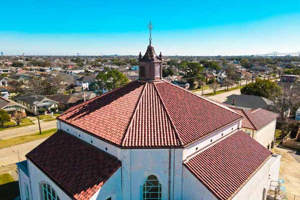 St. Leo the Great Catholic Church in New Orleans with a restored red clay tile roof and copper cupola