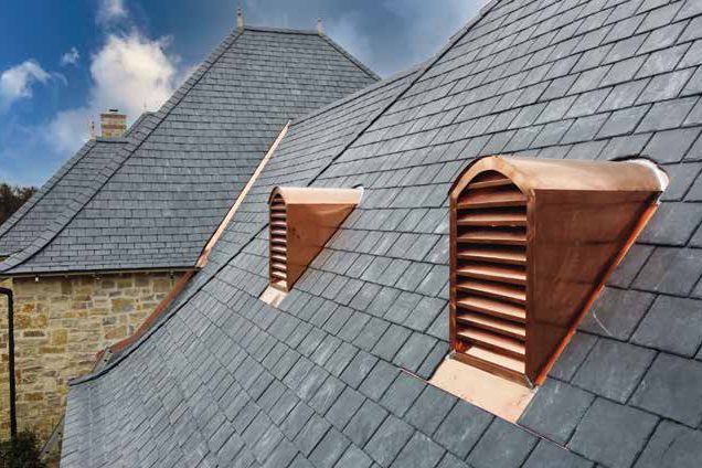 Copper eyebrow dormers on a slate roof