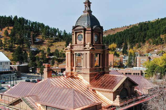 Historic brick building with a new copper roof and restored dome tower
