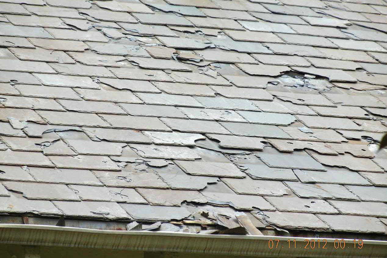 Slate roof with hail-broken and missing pieces