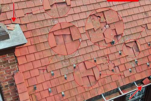 Hail hits circled on a clay tile roof slope
