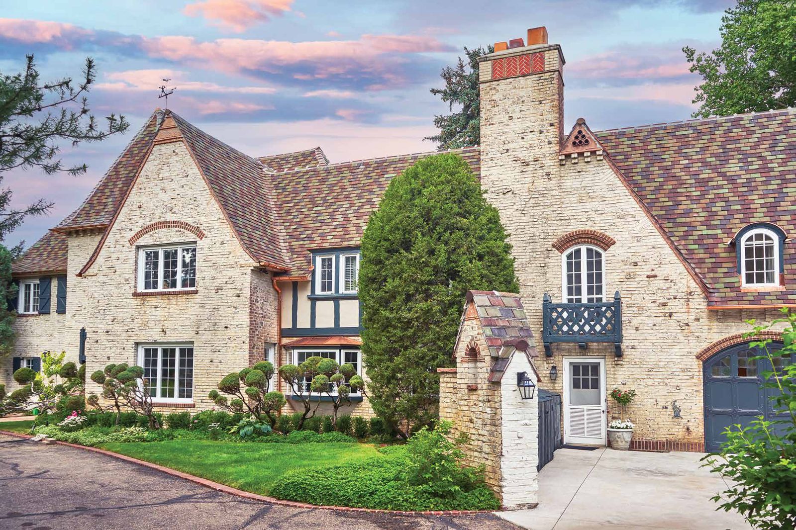 Simon Residence, a stone Tudor home with a blended Ludowici tile roof