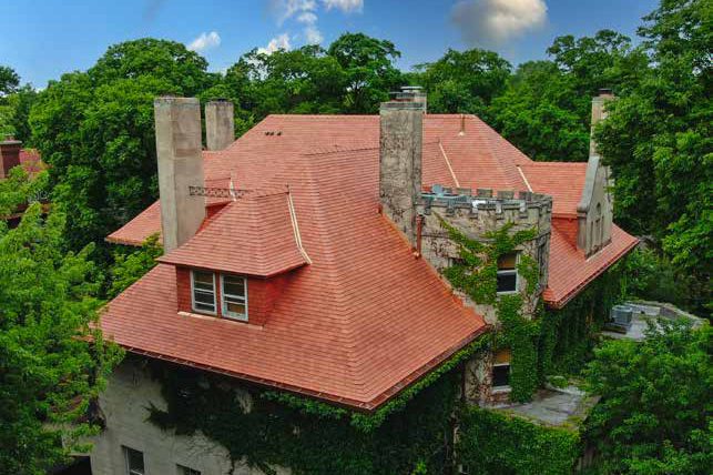Ivy-covered historic home in Evanston with a red clay tile roof