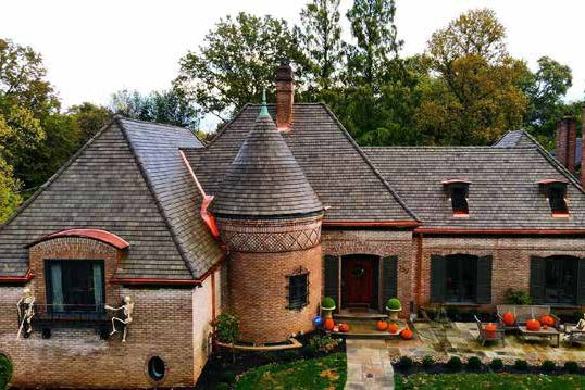 Brick home with a round turret and a new tile roof