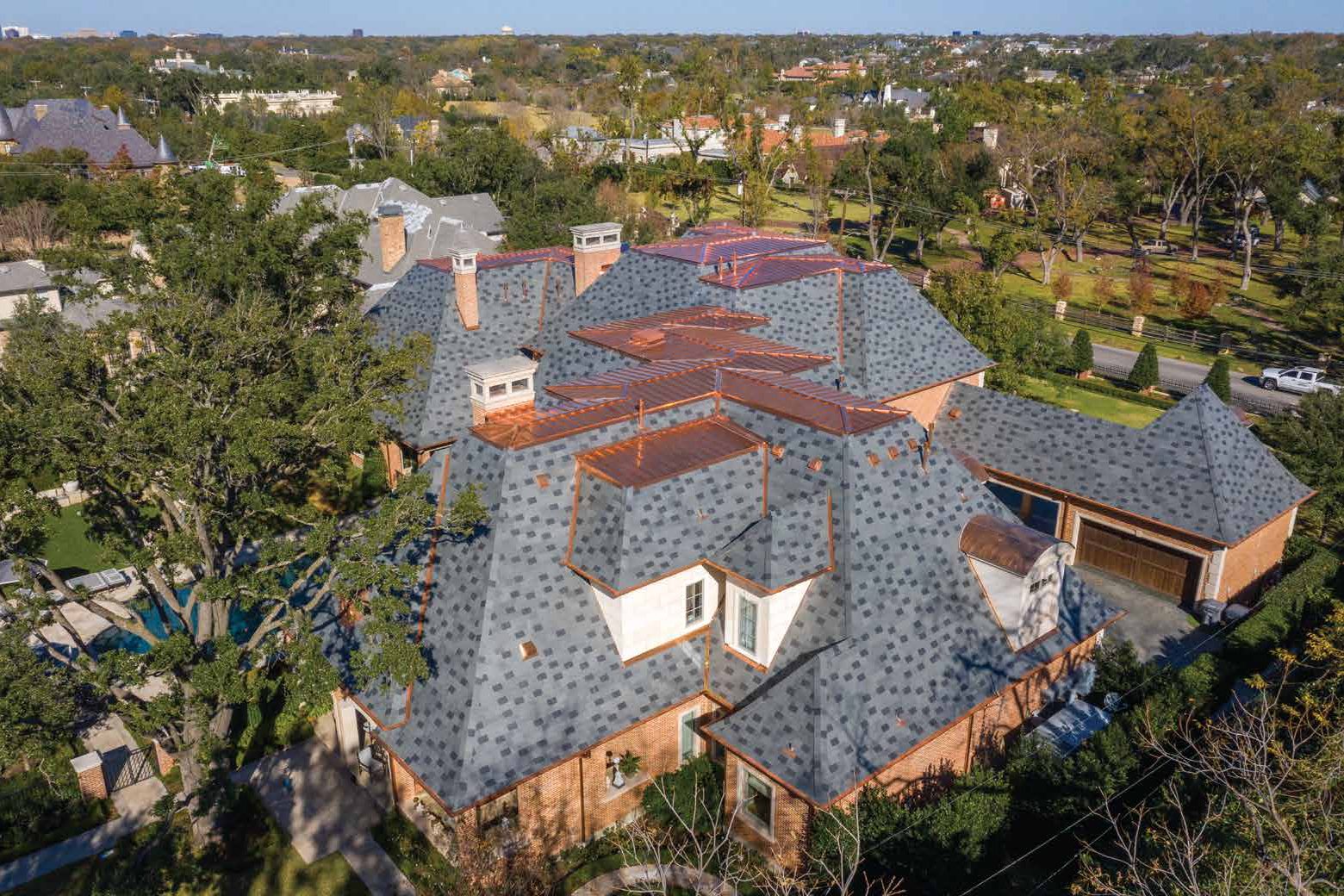 Estate with a natural slate roof and copper details, aerial view