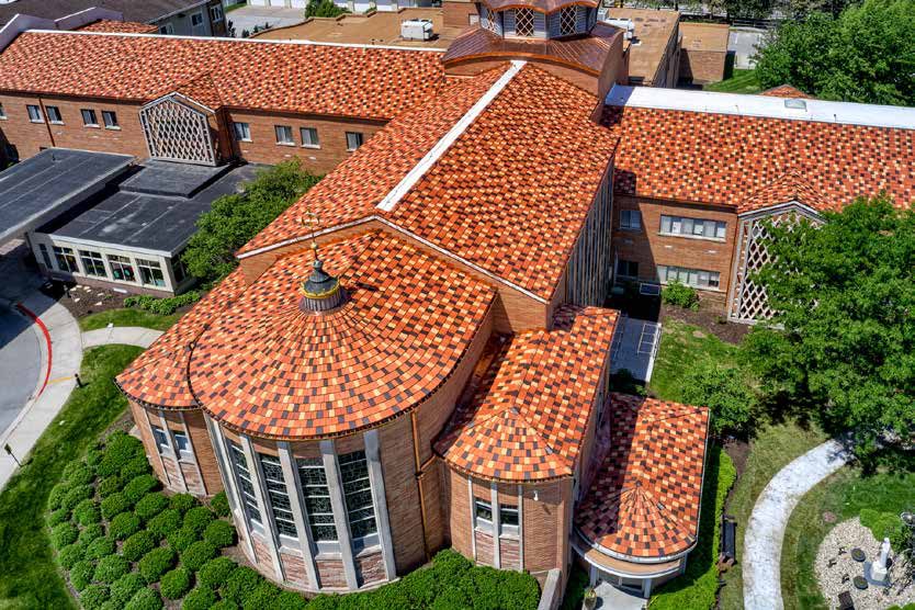 Curved clay tile roof over a round bay of windows
