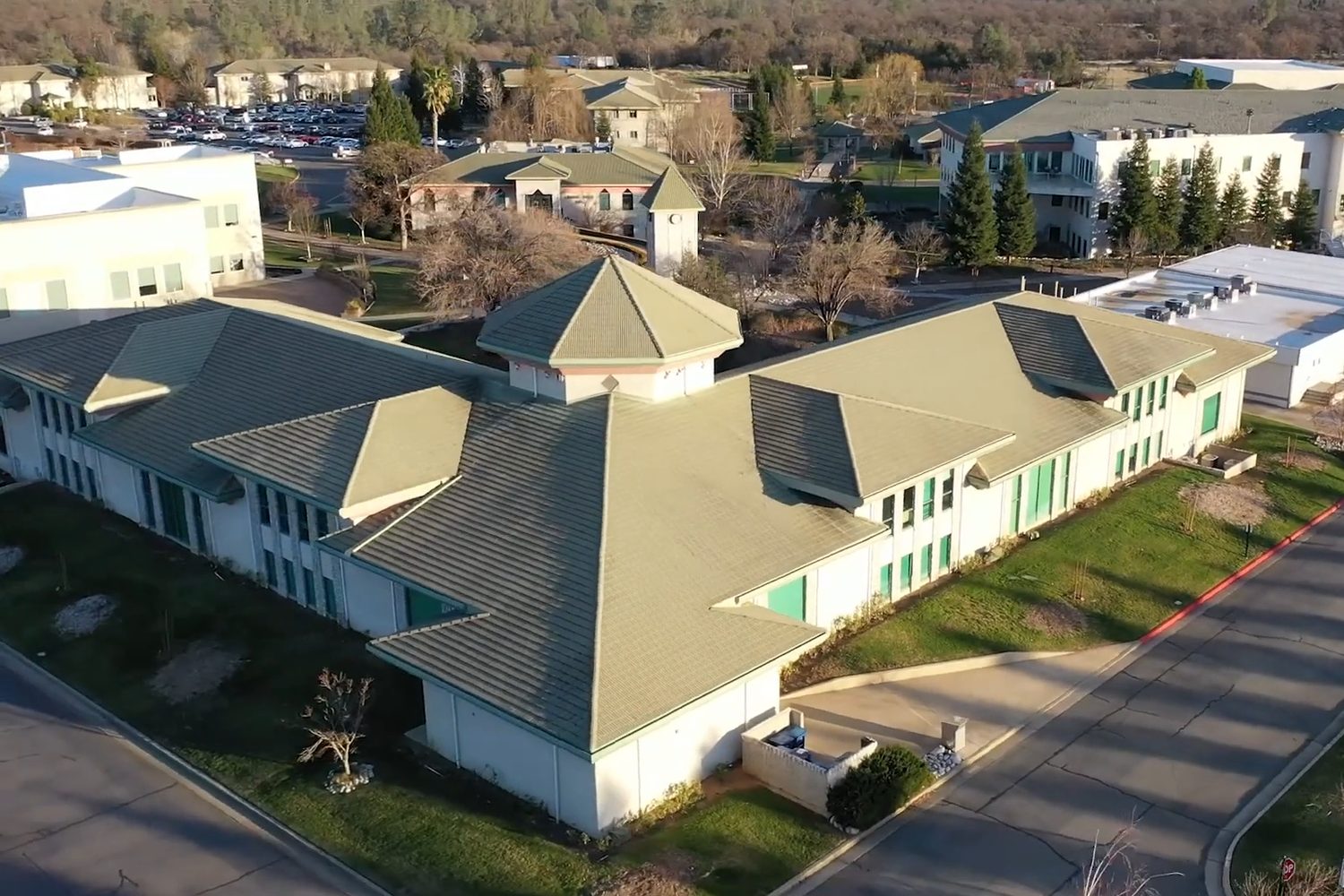 Simpson University campus buildings with tile roofs, aerial view